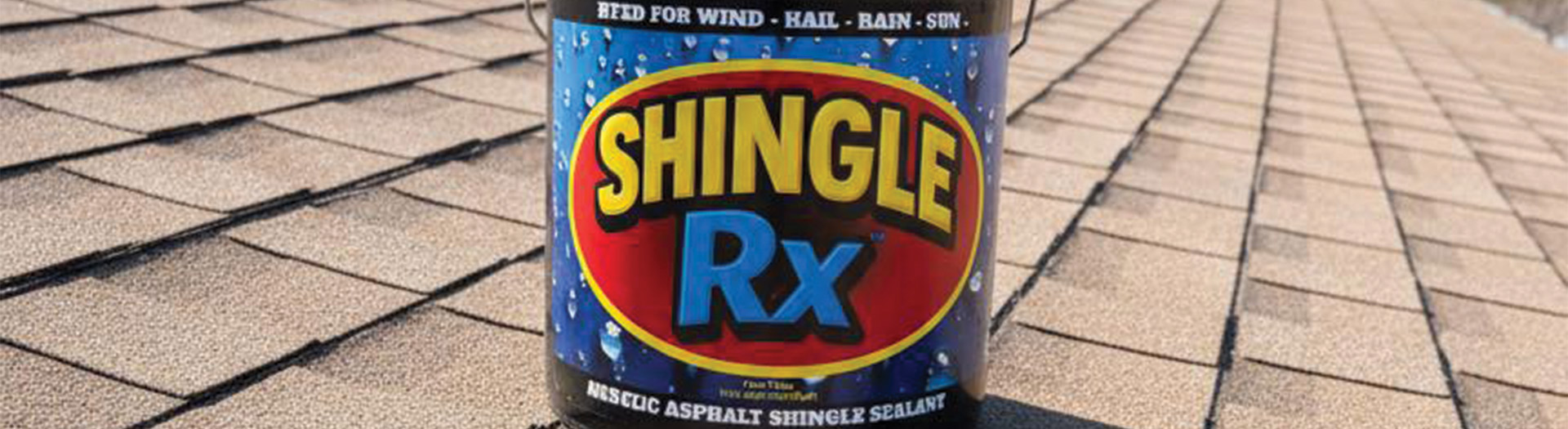 Shingle RX acrylic asphalt shingle sealant bucket sitting directly on asphalt shingles representing Florida roof rejuvenation certifications and AcrySeal authorized dealer status