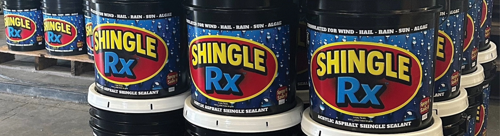 Large pallet wall of Shingle RX acrylic asphalt shingle sealant buckets stacked in warehouse representing Southeast Florida roof rejuvenation product supply